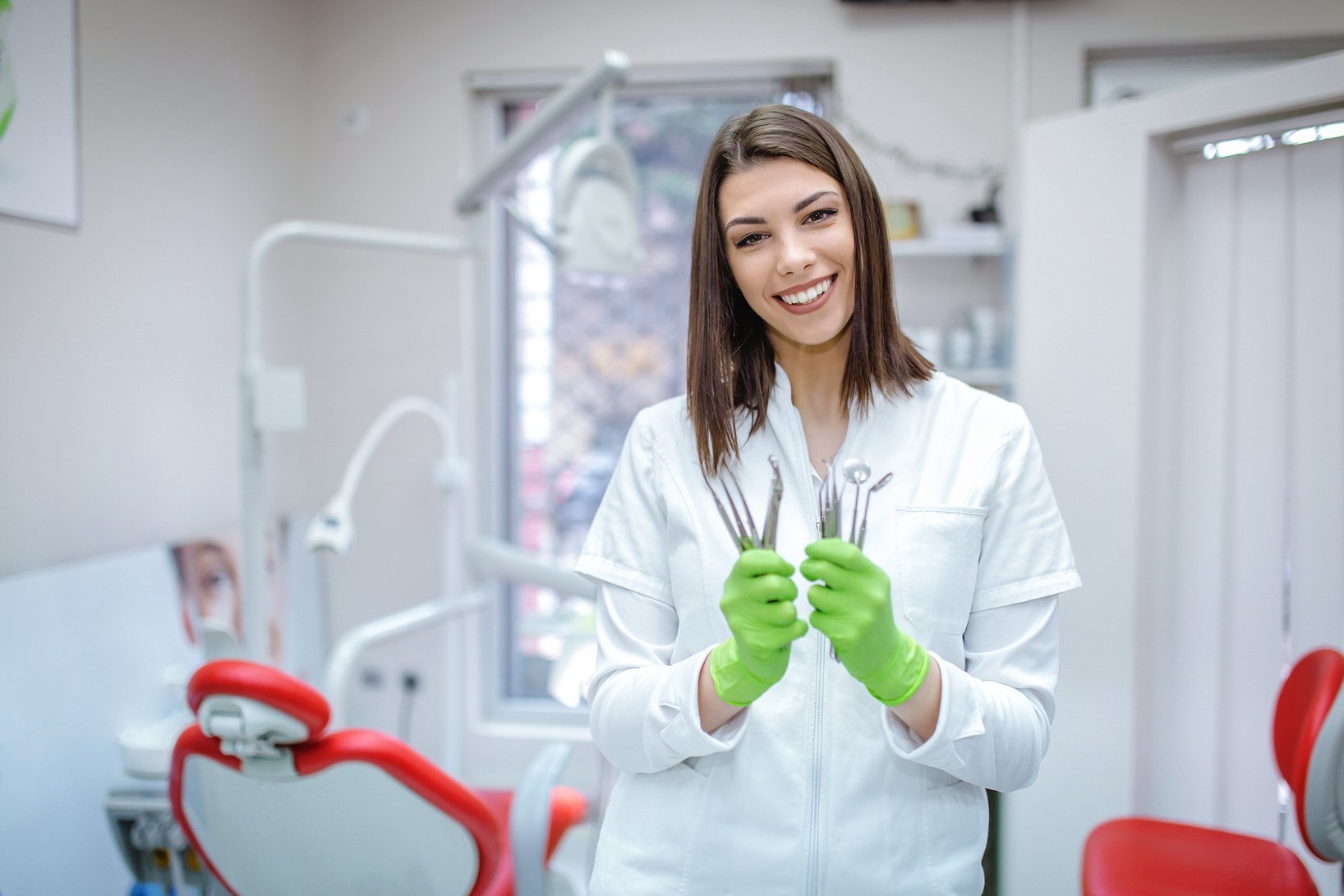 Cute dentist holding dentist instruments